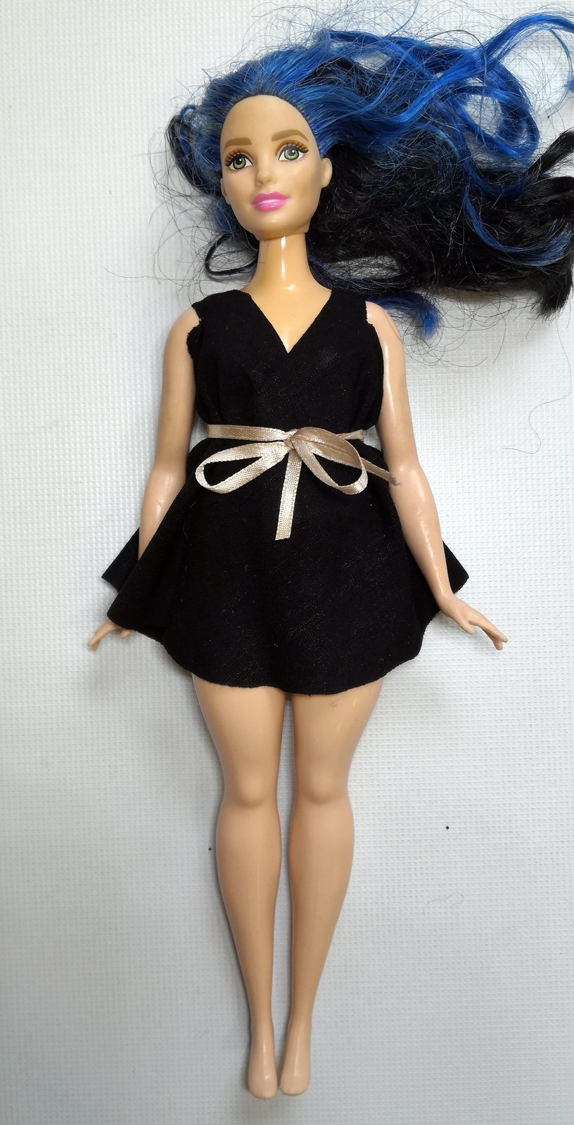The same piece tied at the waist with a ribbon, now a dress